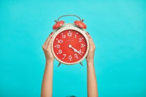 Female Holding Clock